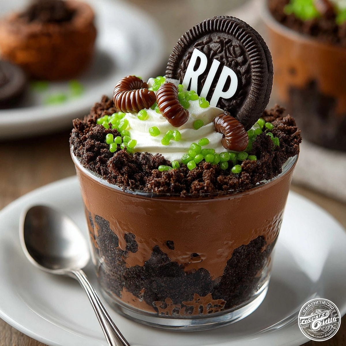 Rich Haunted Graveyard Pudding Cups feature dark chocolate, Oreo dirt, and gummy worms.