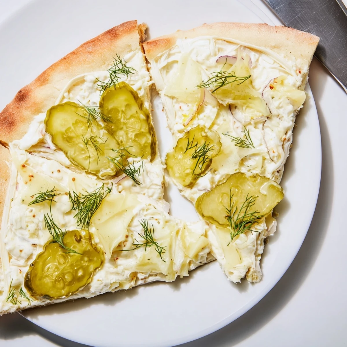 Sliced Pickle Pizza emerging from the oven, showcasing rich crème fraîche and savory toppings.