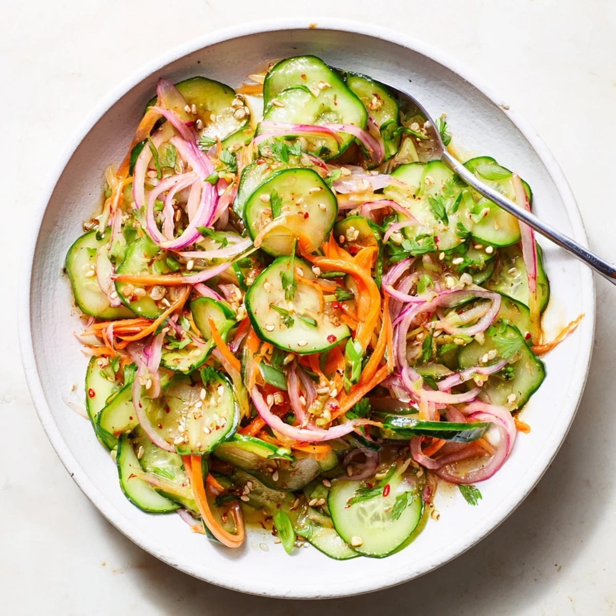 Refreshing cucumber salad remix, featuring vibrant veggies and savory Asian-inspired dressing.  