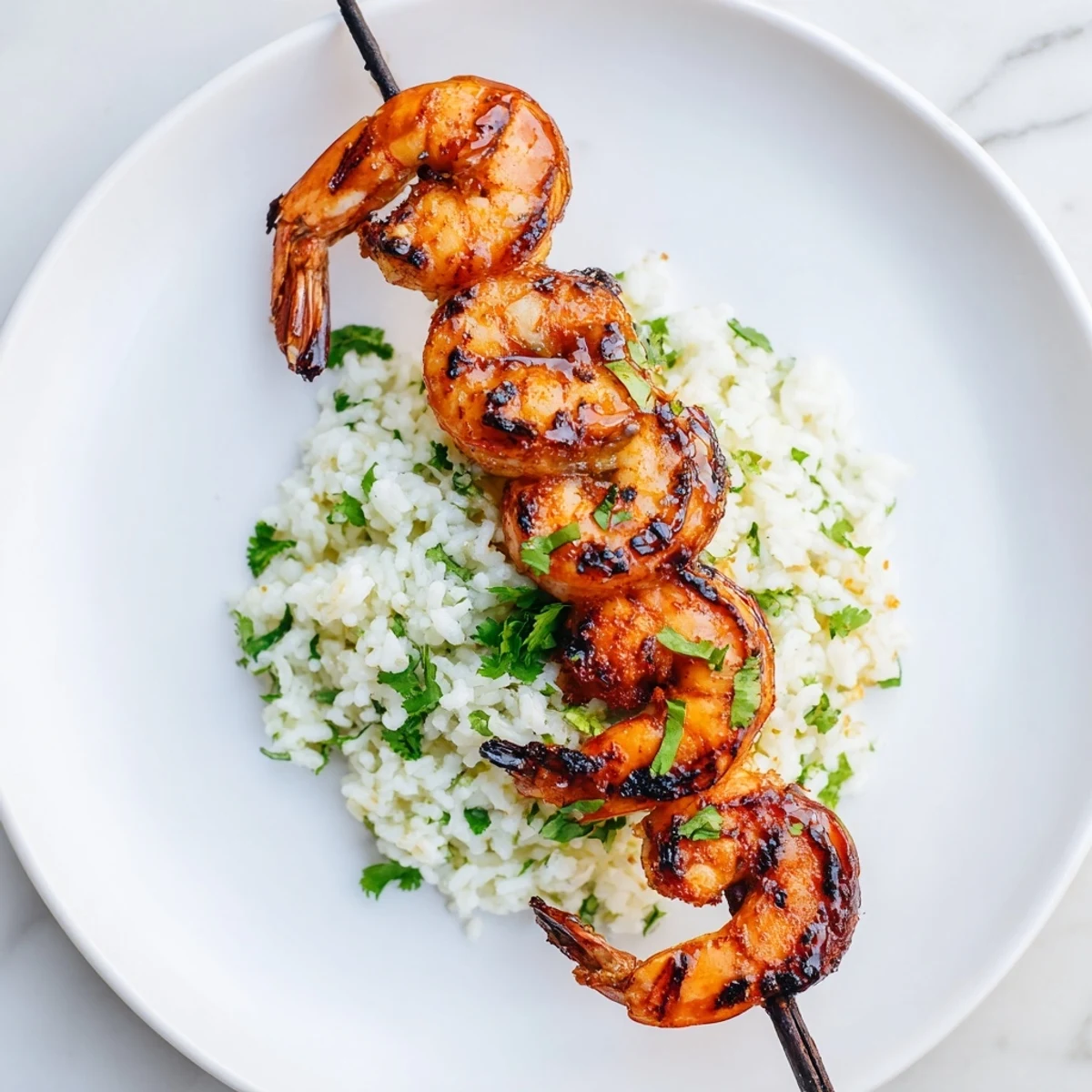 Smoky Chipotle Lime Grilled Shrimp & Rice, beautifully charred shrimp atop fluffy cilantro-lime rice for a delicious meal.