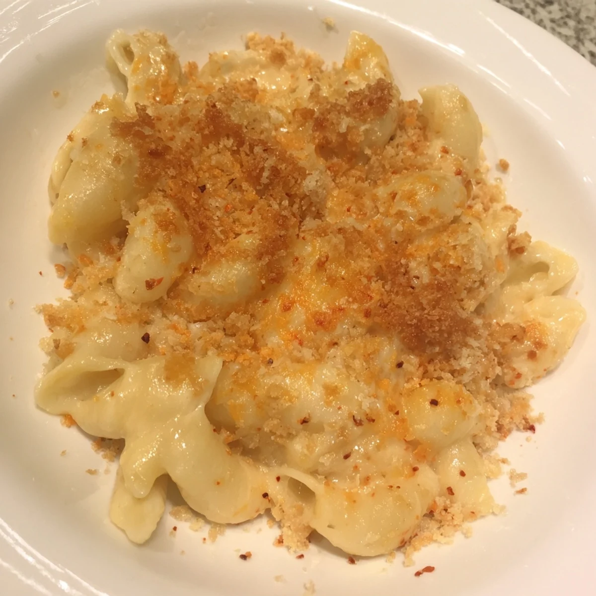 Golden, bubbly baked mac & cheese with evaporated milk, ready for a comforting bite.