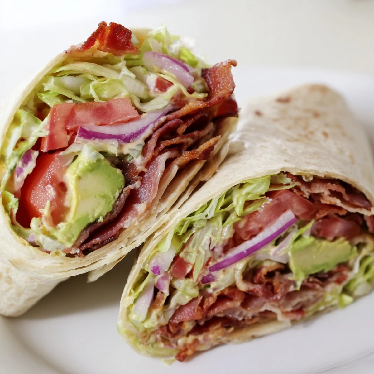 Zesty BLT wraps filled with crispy bacon, fresh tomatoes, and spicy chipotle mayo, ready to eat!