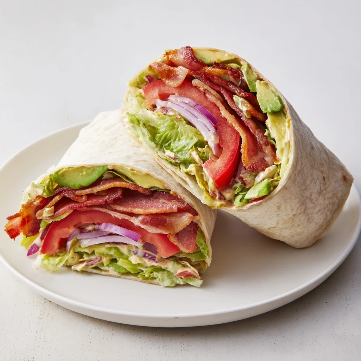 Enjoy a delicious zesty BLT wrap on a plate, a quick and satisfying lunch or dinner idea.
