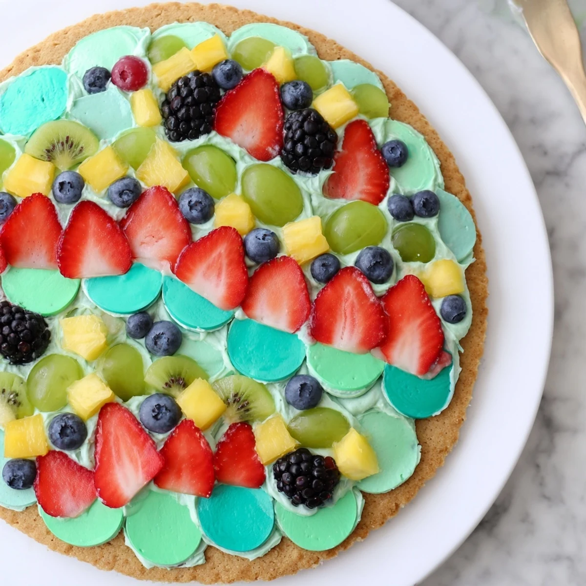 This bright Under the Sea Mermaid Tail Fruit Pizza features vibrant fruit arranged in a festive, mermaid tail.