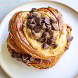 Warm and freshly baked Viral Crookie pastry, showing layers of flaky croissant and a gooey cookie center.