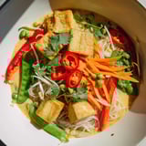 Bright and flavorful Malaysian Laksa, with a creamy coconut curry broth and vibrant vegetables.