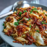 Tender sautéed cabbage, smoky bacon, and sweet onions; a delicious side.