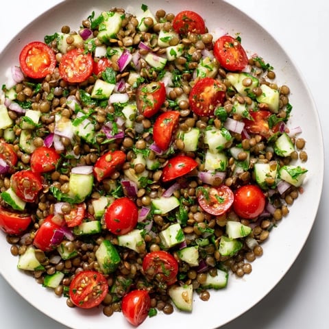 Brightly colored lentil salad, brimming with fresh vegetables, ready for a healthy meal.