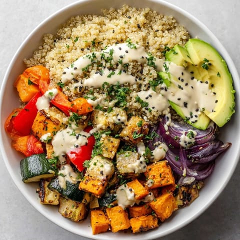 Colorful Quinoa Bowl with Roasted Vegetables and Lemon-Tahini Dressing served fresh for a nourishing vegan meal