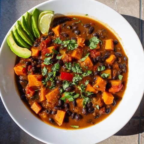 Warm, flavorful Sweet Potato & Black Bean Chili, a comforting, hearty vegetarian main course.