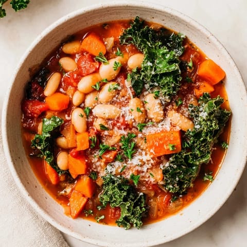 This delicious Italian Bean & Kale Stew boasts a rich, tomato-based broth, perfect for a cozy dinner.