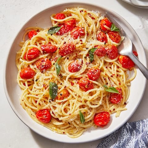 Bright, flavorful Lazy-Girl Pasta with fresh basil and tomatoes in a warm skillet, ready to serve.