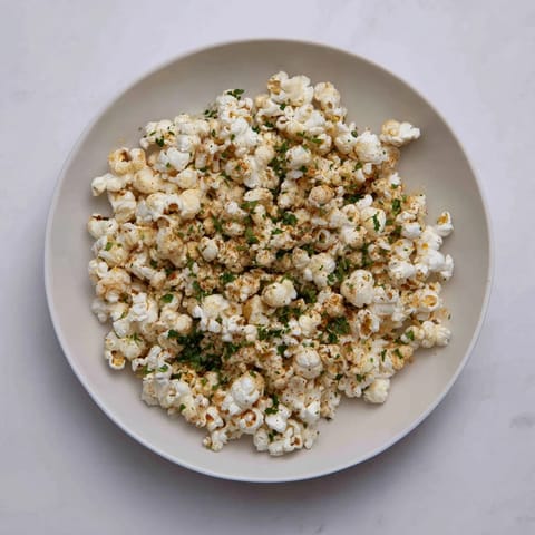 Close-up of a delightful savory popcorn mix, seasoned with herbs, ready to be enjoyed.