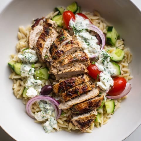 Flavor-packed Greek Chicken Gyro Pasta Bowls with juicy tomatoes and grilled chicken, perfect for a satisfying dinner.