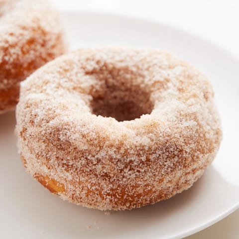 Homemade cinnamon-sugar baked donuts, showing their soft textures after being fresh from oven.