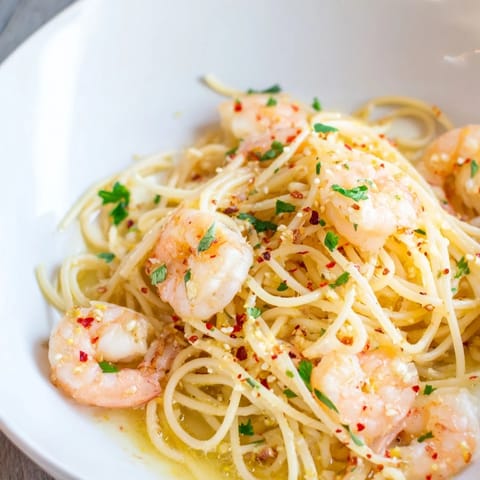 Juicy shrimp sizzling in a zesty lemon garlic butter sauce, ready to be tossed with al dente spaghetti.