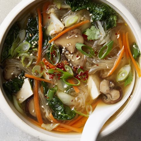 A close-up view shows tender napa cabbage and shiitake mushrooms swimming in the savory miso broth.  