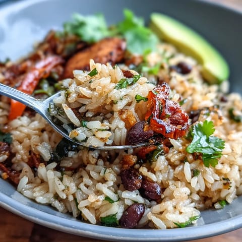 Vibrant vegan fajita rice skillet with colorful peppers and black beans in a sizzling pan.  