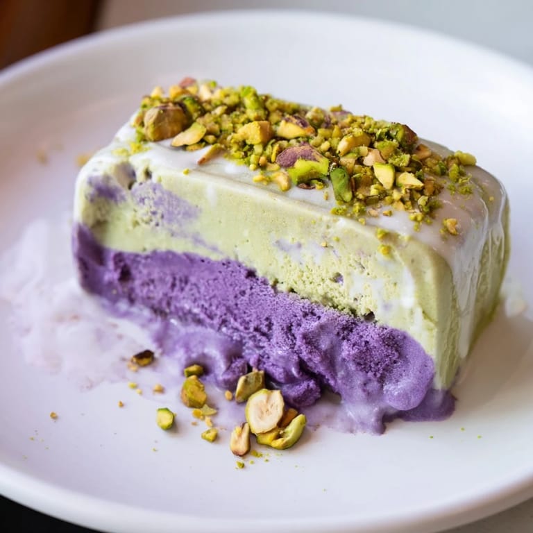 Homemade ube and pistachio ice cream bars topped with crunchy pistachios.