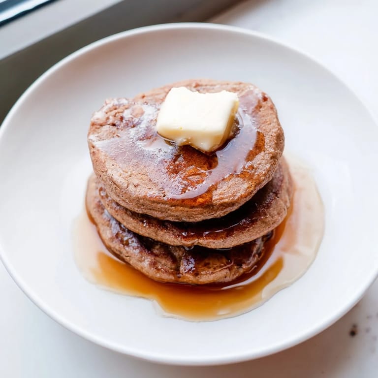 Delicious stack of freshly cooked gingerbread pancakes, perfect for a cozy winter brunch with family.