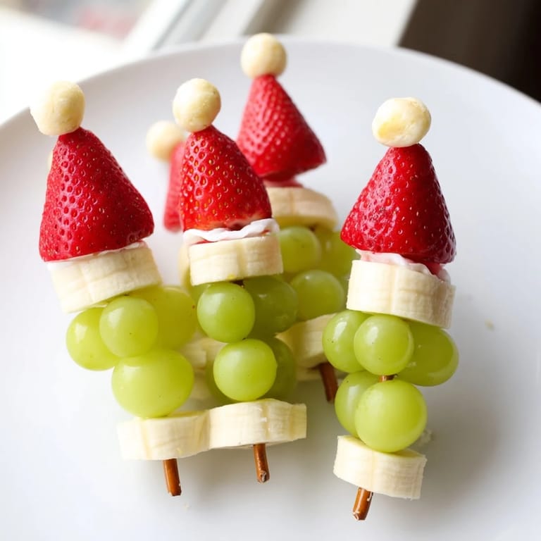 Delicious Elf Hat Strawberry Skewers, a fun treat: juicy strawberries and banana slices arranged like miniature hats.