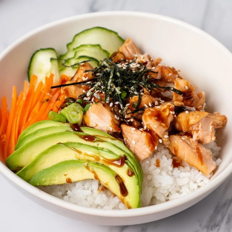 Imagine the savory Japanese-Style Salmon & Chicken Rice Bowl: a satisfying and colorful meal.