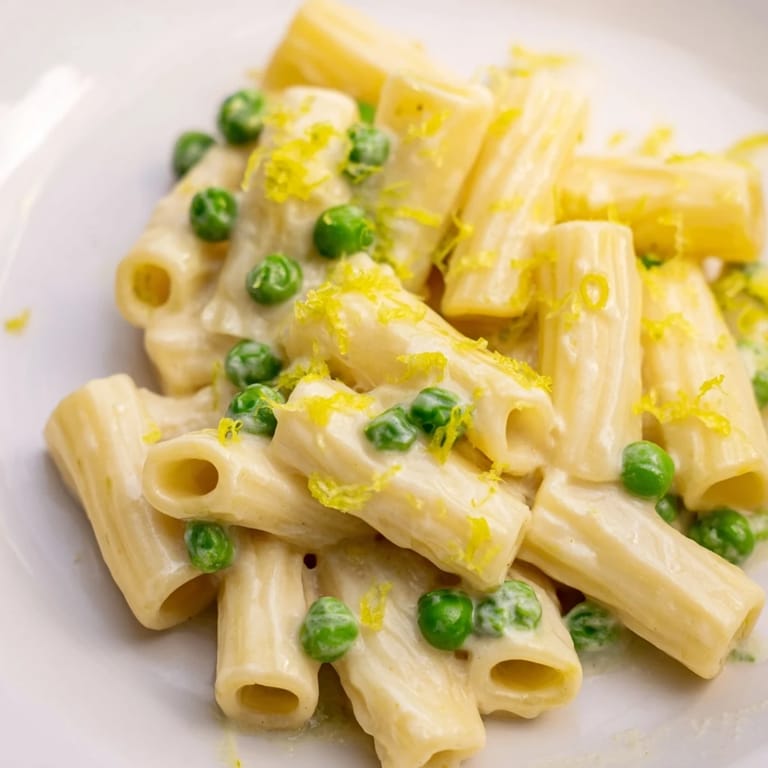 Steaming Pea & Lemon Ricotta Pasta served in a white bowl, topped with extra Parmesan and lemon zest for a refreshing weeknight meal.