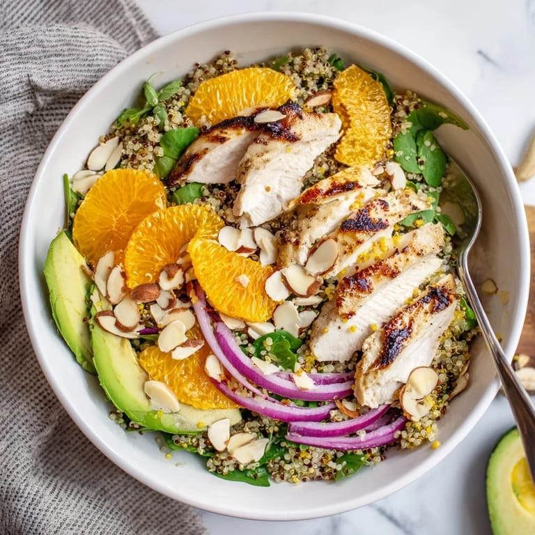 A drizzle of zesty citrus vinaigrette finishes this colorful salad bowl, garnished with toasted almonds for a satisfying crunch.