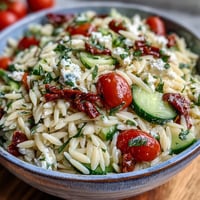 Vibrant Mediterranean Lemon Orzo salad with fresh veggies and crumbled feta.