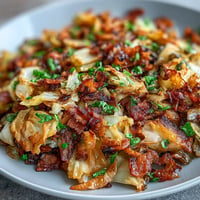 Southern fried cabbage with bacon, onions, and golden-brown caramelized bits.