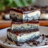 Creamy black sesame cheesecake bars with a crisp cookie crust, ready to slice.
